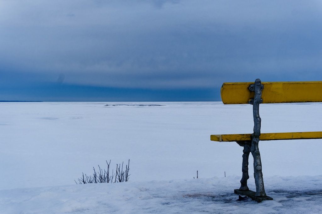 Blueish sky, yellow bench.